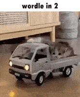 a cat is sleeping in the back of a toy truck
