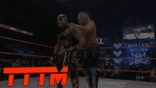 a blurred image of a wrestling match with the letters tim in red
