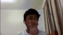 a young boy wearing earbuds looks at the camera