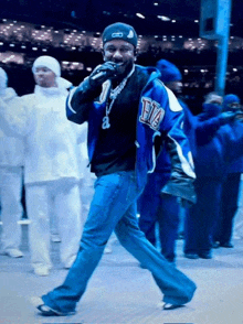 a man wearing a blue jacket with the letter e on it