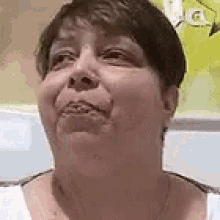 a close up of a woman 's face with a slight smile on her face .