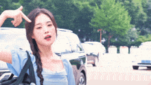 a woman in a blue shirt is making a funny face