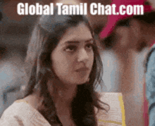 a woman is looking at the camera with the words `` global tamil chat.com '' written on the bottom .