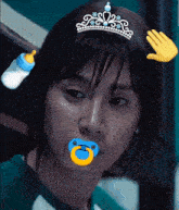 a woman with a pacifier in her mouth wearing a tiara