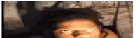 a close up of a person 's face with a shadow on the wall behind them .
