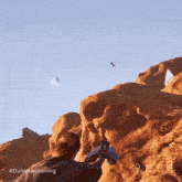 a dune awakening poster with a person holding a gun
