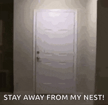 a door with the words " stay away from my nest " written on it