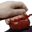 a person with a beard is eating an apple with a knife .