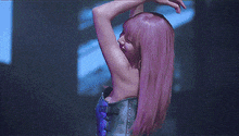 a woman with pink hair is wearing a purple corset