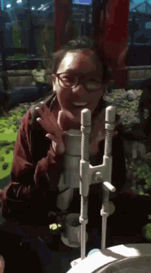 a woman wearing glasses is smiling while playing a game