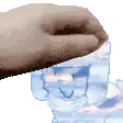 a person is holding a glass of water with a face on it .