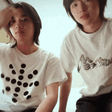 a man and a woman wearing white t-shirts with the word consun on them