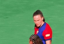 two female soccer players are hugging each other and one has a nike logo on her shirt
