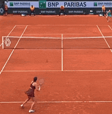 a tennis court with a bnp paribas banner on the side