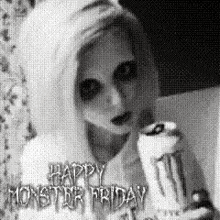 a black and white photo of a woman holding a cake with the words `` happy monster friday '' written on it .
