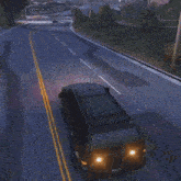 a black suv is driving through an intersection with a white arrow pointing to the right