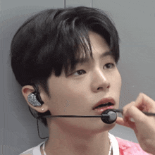 a close up of a person wearing a microphone on their ear