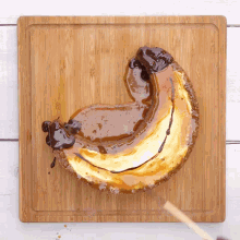 a banana shaped dessert on a wooden board