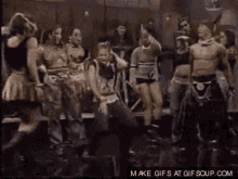 a group of people dancing in a dark room with the words make gifs at gifsoup.com