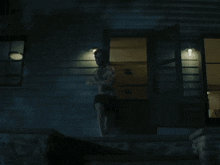 a man without a shirt is standing in front of a house