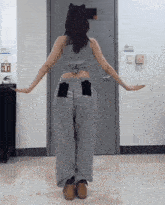 a woman is standing in front of a door with her arms outstretched ..