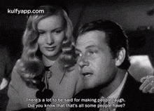 a man and a woman are sitting next to each other in a black and white photo .