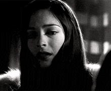a woman 's face is shown in a black and white photo .