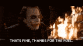 the joker is standing in front of a fire and saying `` that 's fine , thanks for the fuel '' .
