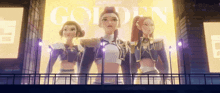 a group of three women standing in front of a sign that says golden