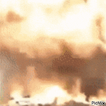 a large explosion with a lot of smoke and dust coming out of it .