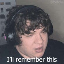 a man wearing headphones says " i 'll remember this " in front of him