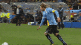 a soccer player with the number 33 on his jersey jumps to catch a ball