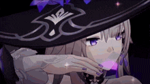 a close up of a girl wearing a witch hat with purple nails .