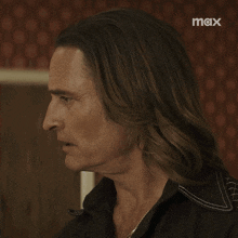 a man with long hair has the word what written on his face