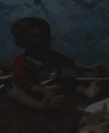 a blurry picture of a child in a red shirt