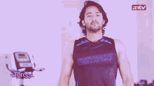 a man wearing a westsport tank top blowing a kiss