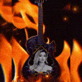 a guitar with a picture of a woman on it with flames in the background