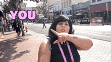 a woman making a gesture with the word you above her