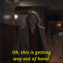 a woman in a trench coat is saying oh this is getting way out of hand