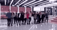 a group of people are posing for a picture in a large room .