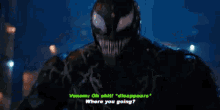 a man in a black jacket is talking to venom in a dark room in a movie .