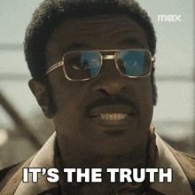 a man wearing glasses says " it 's the truth " in front of him