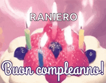 a birthday cake with candles on it and the words `` buon compleanno '' written below it .