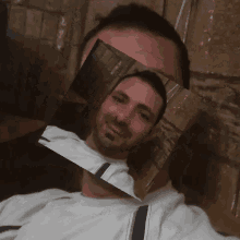 a man is taking a selfie with a picture of his face in the middle