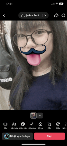 a girl with glasses and a mustache on her face is on a phone screen at 17:41