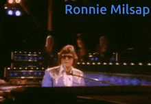 a man singing into a microphone with the name ronnie milsap written above him