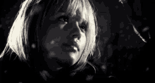 a black and white photo of a woman with blonde hair and bangs