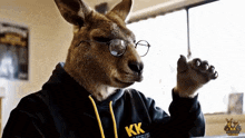 a kangaroo wearing glasses and a kk aussie shirt