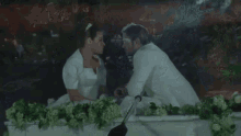 a bride and groom are sitting in a white carriage