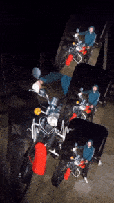 a man is riding a red motorcycle in a dark room